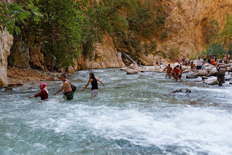 Tourists crossing the river