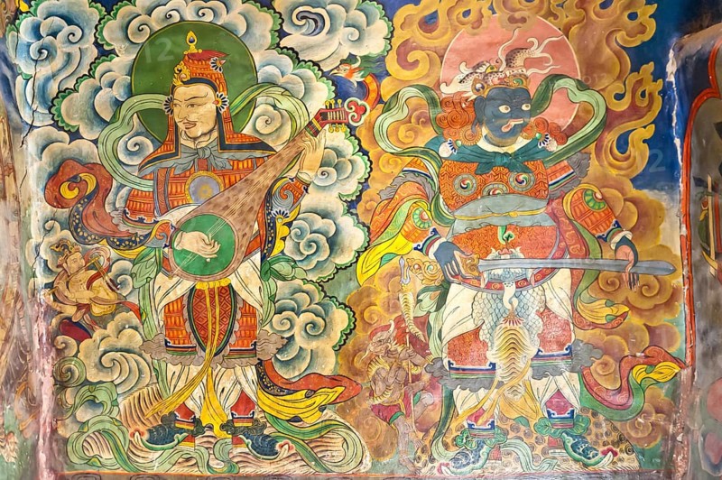 Musicians and demon mural at the entrance of the Tashi Choling Gompa