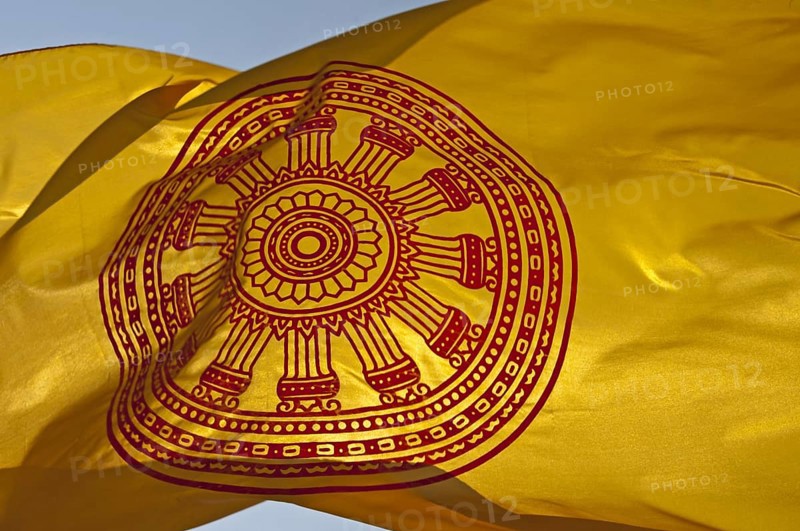 Buddhist flag with the Dharmacakra wheel symbolizing the Buddha's teachings