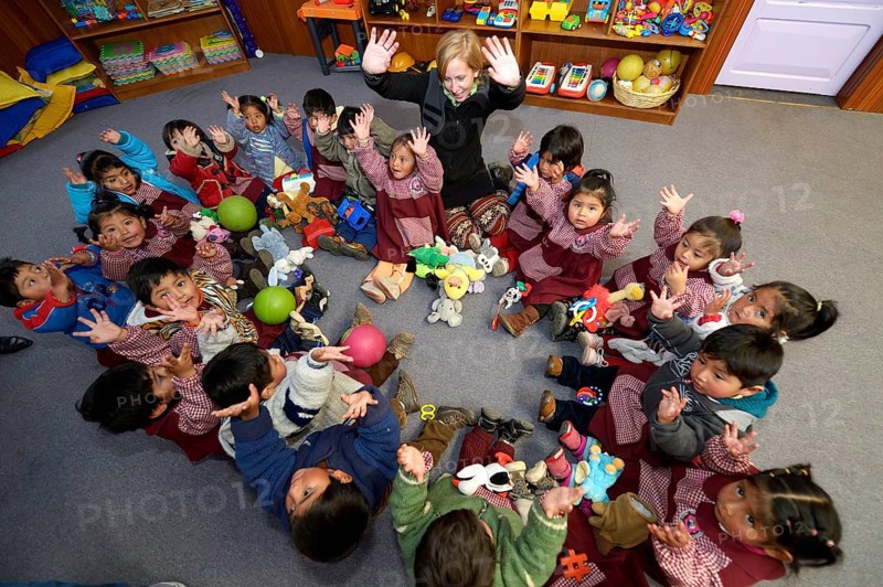 Children sitting on the floor in a circle in a kindergarten