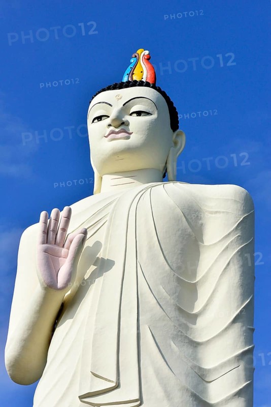 Large Buddha figure in front of a monastery near Sigiriya
