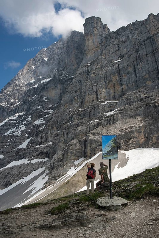 Info panel and hikers on the Eiger Trail