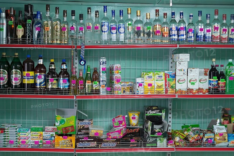 Alcoholic beverages and sweets on sale at a village market