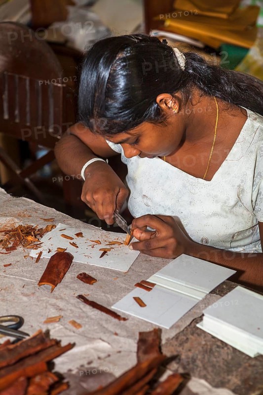 Young woman making wood jewelry