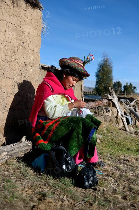 Young woman embroidering a cloth with traditional patterns