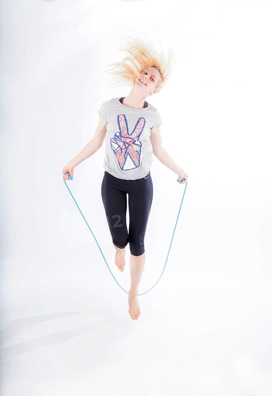 Woman in sportswear jumping rope