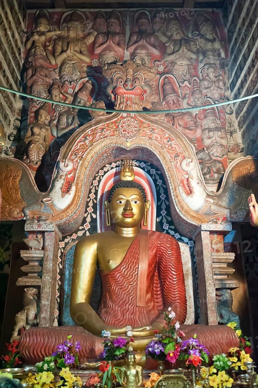 Large brightly painted golden Buddha figure