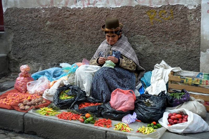 Old market woman in the traditional costume of the Quechua people