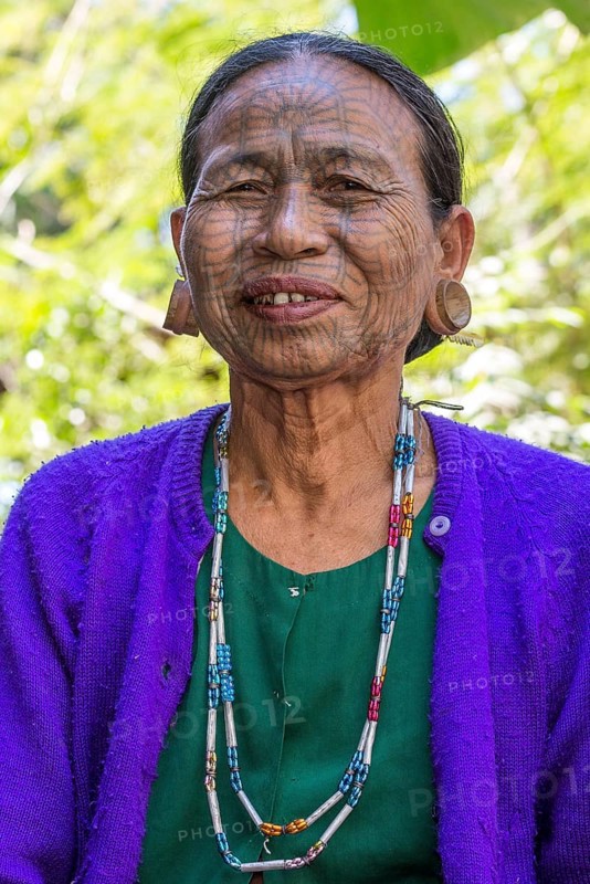 Woman with a traditional facial tattoo and ear jewelry