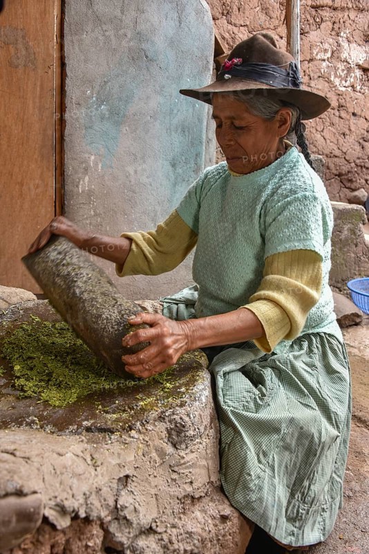 Local woman mortaring herbs