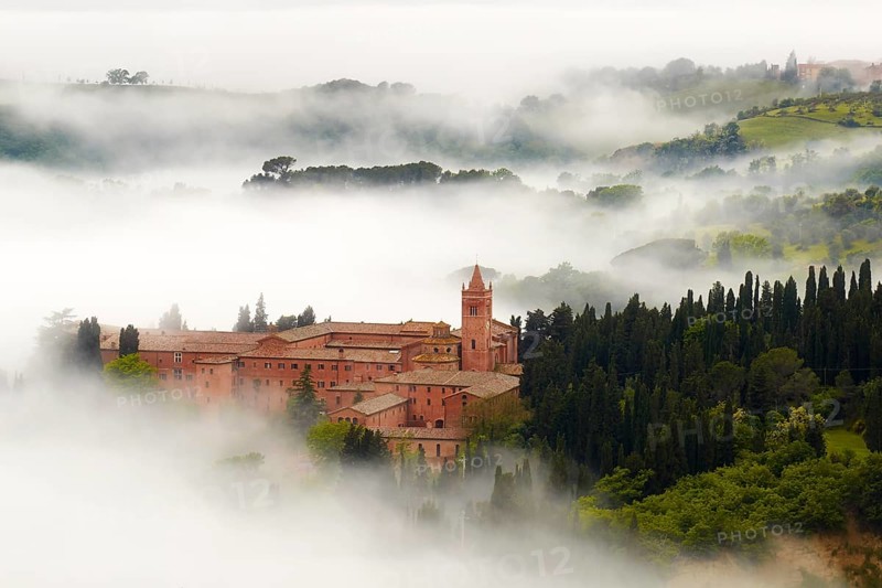Monte Oliveto Maggiore abbey with mist-shrouded valleys