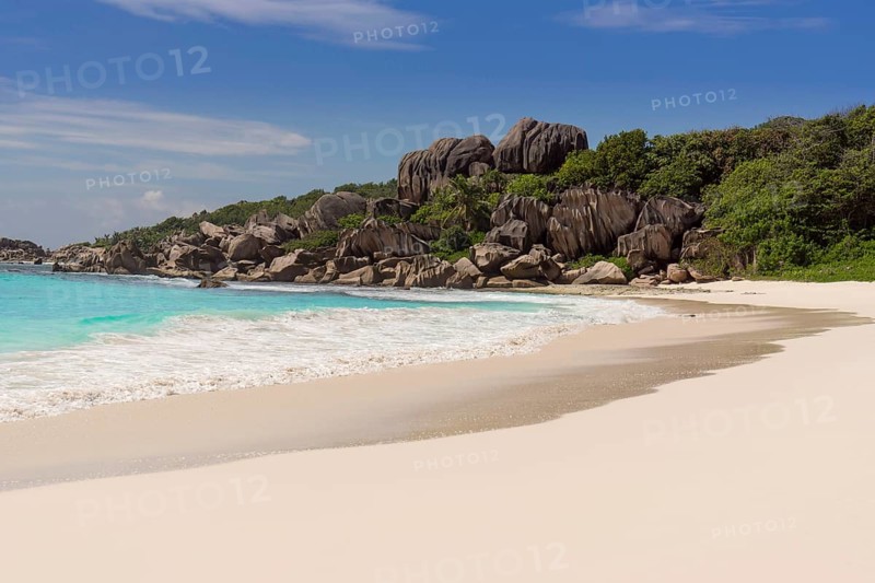 Sandy beach with the rock formations typical for the Seychelles