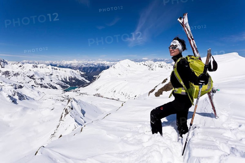 Winter sportswoman on a mountain peak