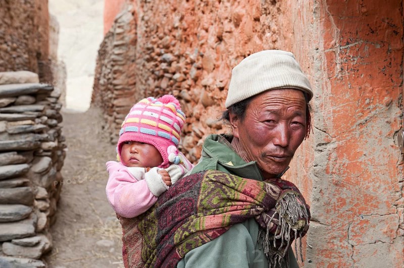 Man carrying a baby on his back