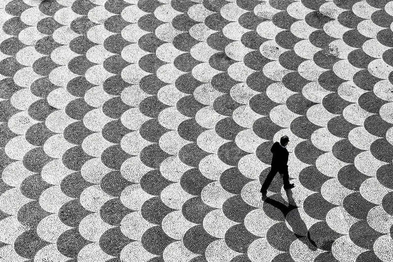 Person seen from above crossing Praca do Municipio square