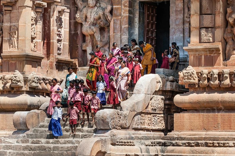 Children and devout Hindus descending a staircase