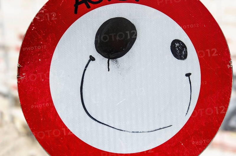 Road sign with a painted face