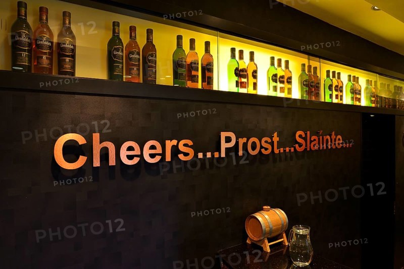 Whiskey bottles and lettering 'cheers