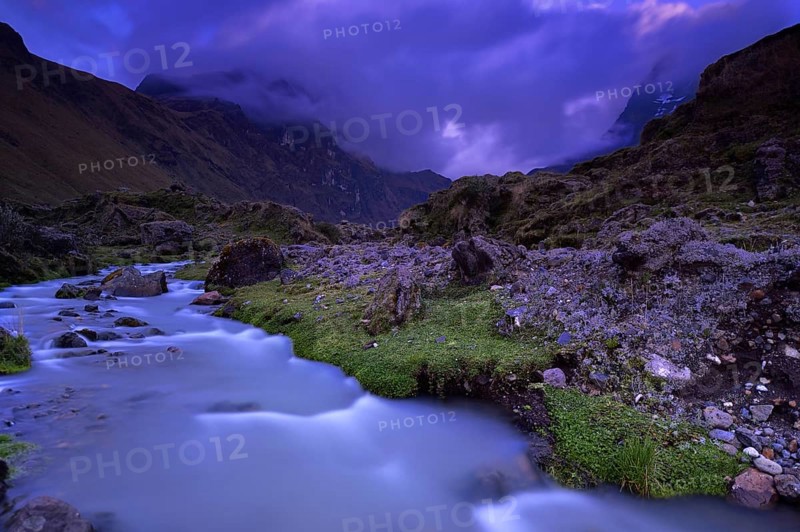 Mountain stream with the peaks of El Altar or Kapak Urku