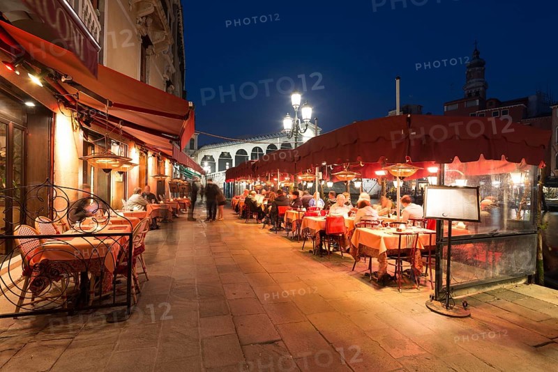 Outdoor restaurant in front of the Rialto Bridge
