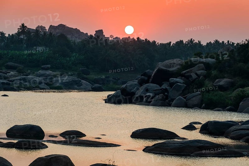 Sunset over Tungabhadra river and a part of the ruins of the former Vijayanagara Empire