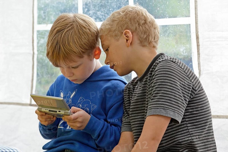 Two boys playing Nintendo