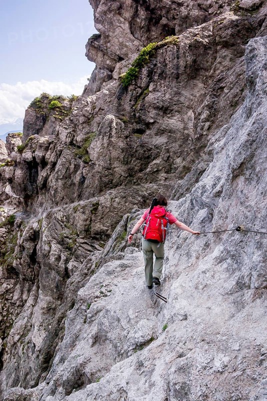 Female hiker walking along the fixed cable route of Jubilaeumssteig
