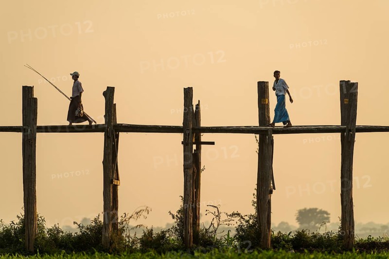 Locals walking on a teak bridge