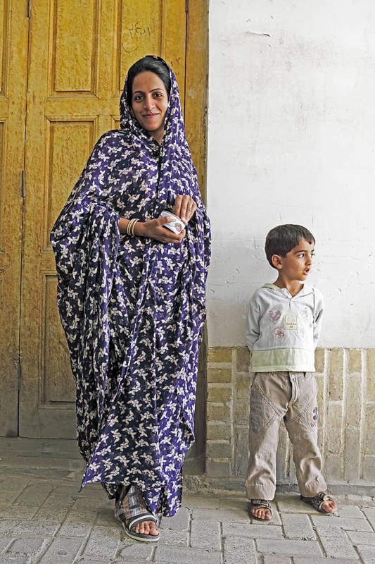 Woman in modern chador with son