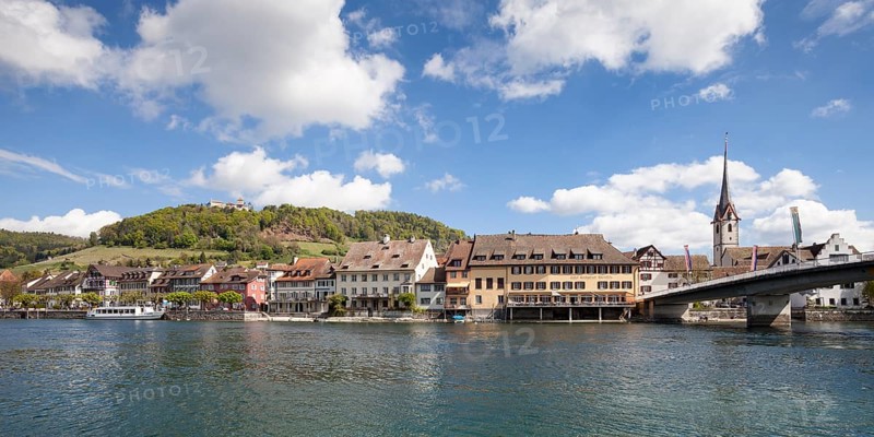 Townscape on the bank of the Rhine River with a boat landing and Burg Hohenklingen Castle