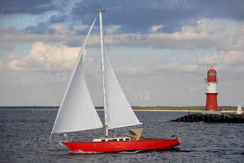 Red Lighthouse and a red sailing boat