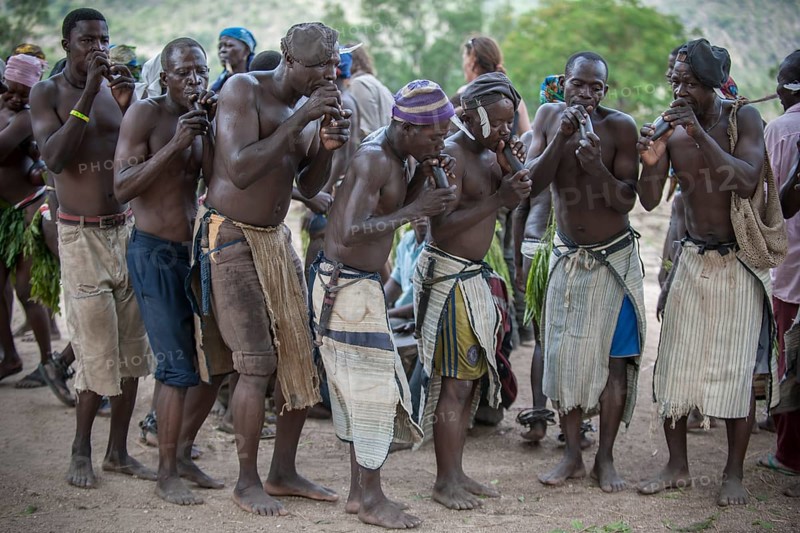 Men of the Koma people dancing and making music