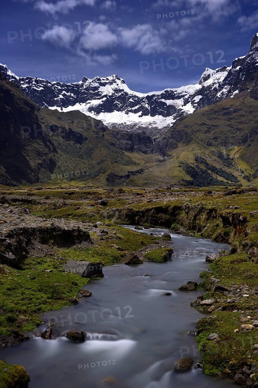Mountain stream with the peaks of El Altar or Kapak Urku