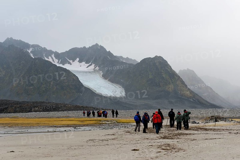 Tourists hiking at Magdalene Fjord