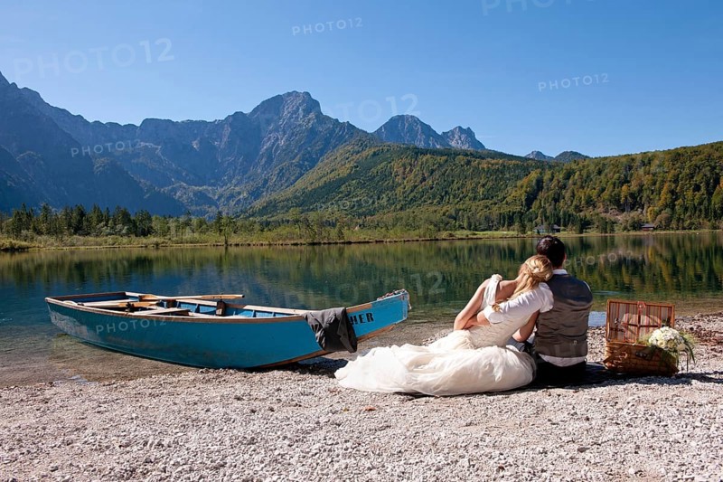 Wedding couple with a boat at Almsee Lake