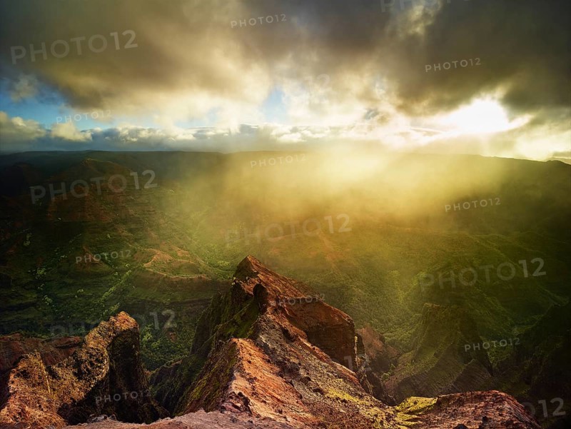 Sunbeams penetrating the dense rain clouds at Waimea Canyon