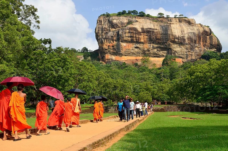 Buddhist monks on their way to the Lion Rock