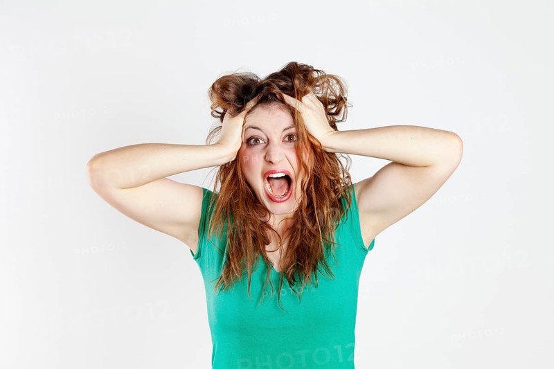 Desperate young woman tearing her hair