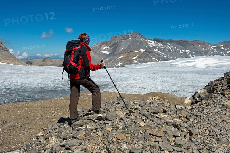 Hiker looking from Pointe de la Plaine Morte over the Plaine Morte Glacier Plateau towards the summit of Wildstrubel Mountain