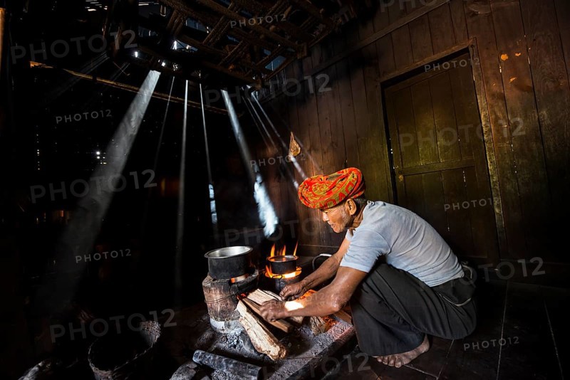 Elderly man at an open fire in the hut