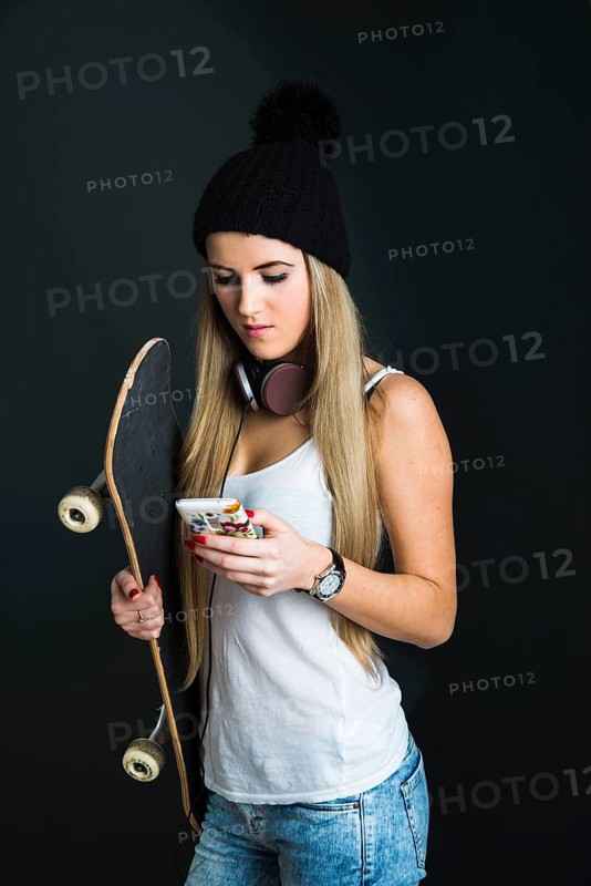Cool young woman with a skateboard