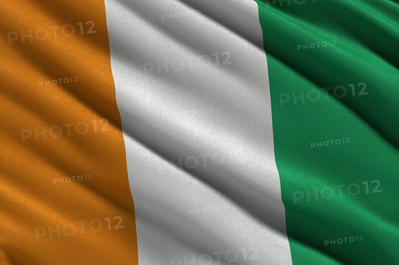 Flag of the Ivory Coast or Republic of Cote d'Ivoire waving in the wind