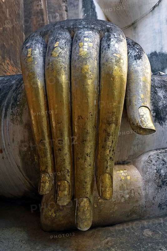 Gilded hand of the Buddha statue Phra Achana