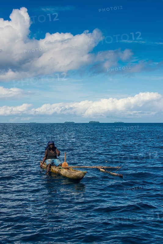 Fishing woman in an outrigger boat