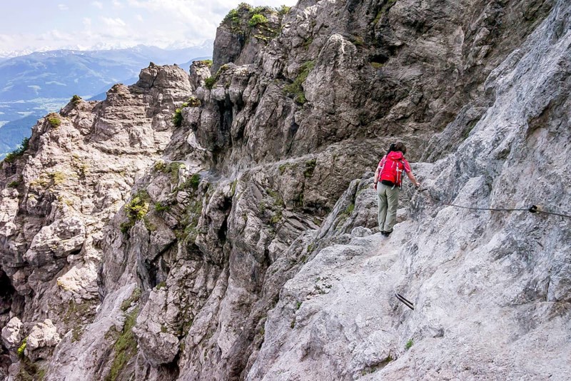 Female hiker walking along the fixed cable route of Jubilaeumssteig
