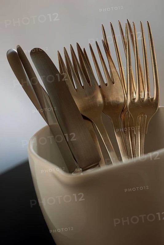 Old silverplated cutlery in milk jug
