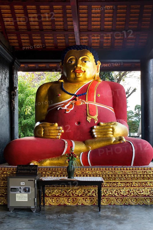 Gilded Buddha beside a safe in the courtyard of Wat Chedi Luang Temple