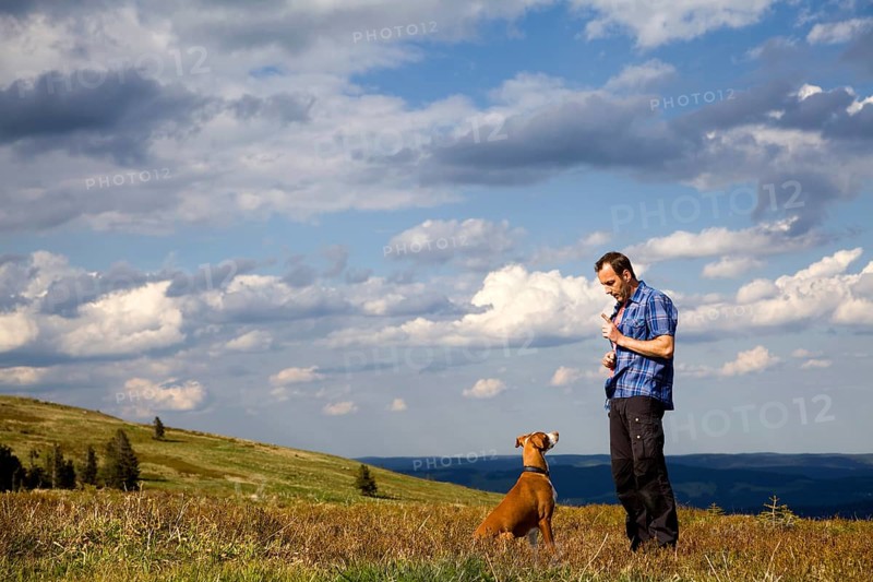 Man making his dog 'sit'