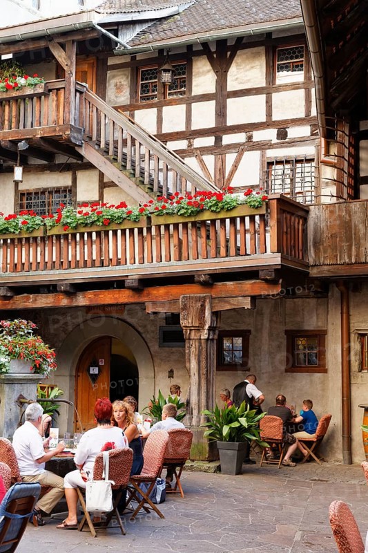 Courtyard of Schattenburg Castle with a restaurant