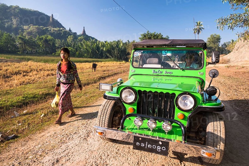 Woman walking next to a four-wheel drive vehicle